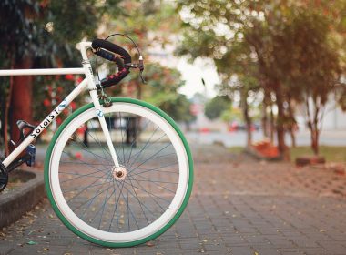 white and black city bike on brown brick floor during daytime