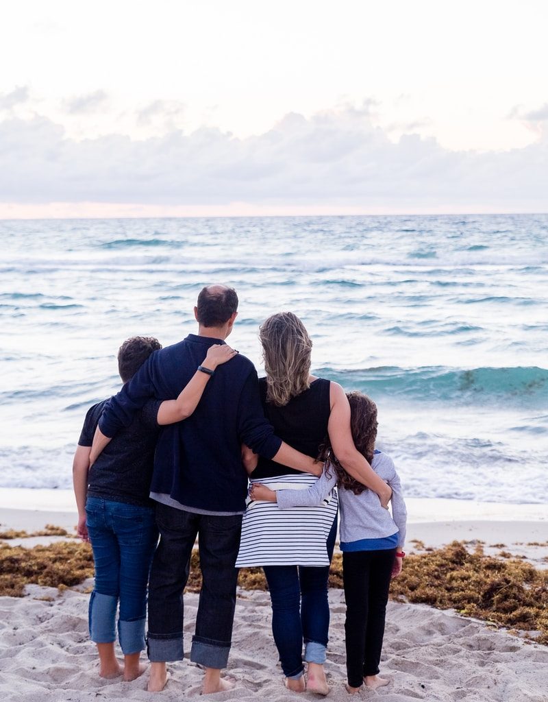 a family of four on a beach
