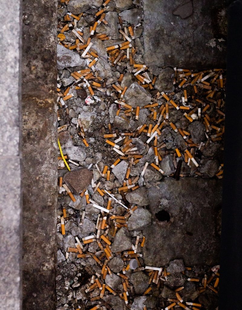 cigarette butts scattered on the ground