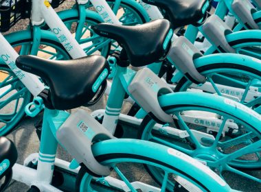 teal bicycle with white plastic bottles