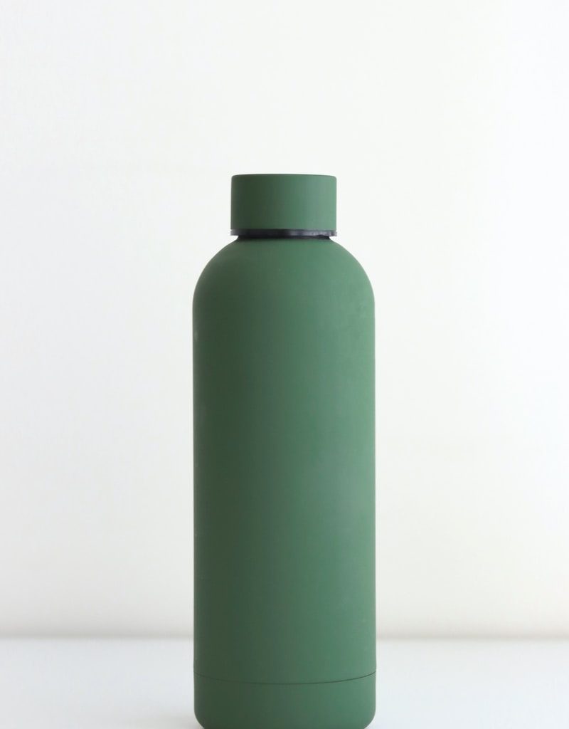 green bottle on white table