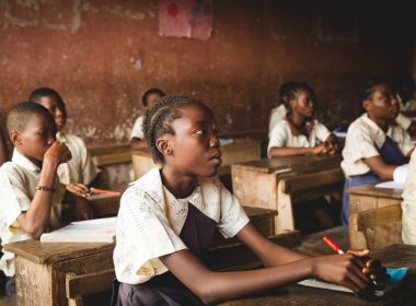 children sitting on chairs inside classroom