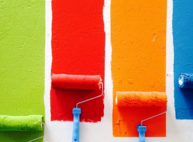 four orange, green, blue, and red paint rollers
