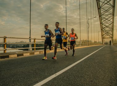 four men running on asphalt floor
