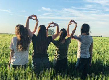 women forming heart gestures during daytime