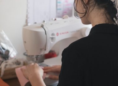 man in black shirt using sewing machine