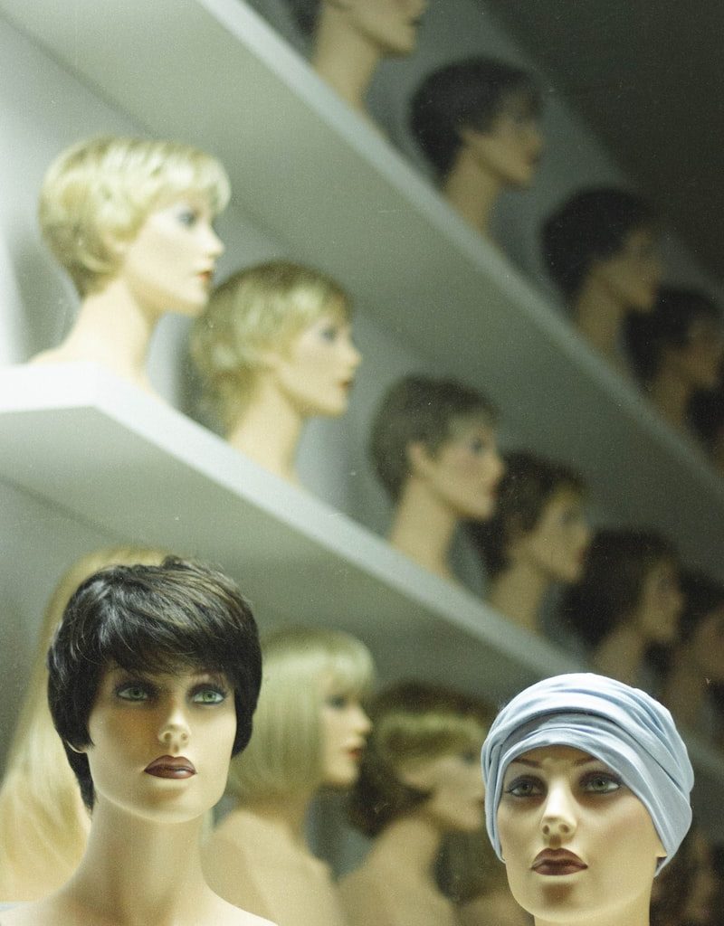 woman in white hijab beside woman in black shirt