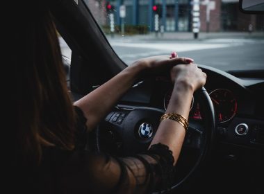 woman inside BMW car holding steering wheel