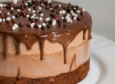 chocolate cake with white icing on white ceramic plate