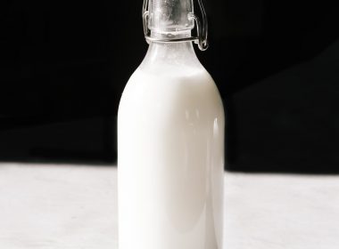 clear glass bottle filled with white liquid