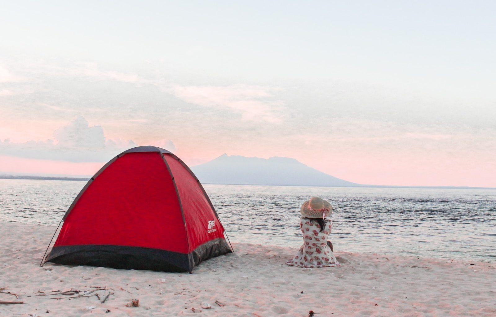 red and black dome tent near seashore