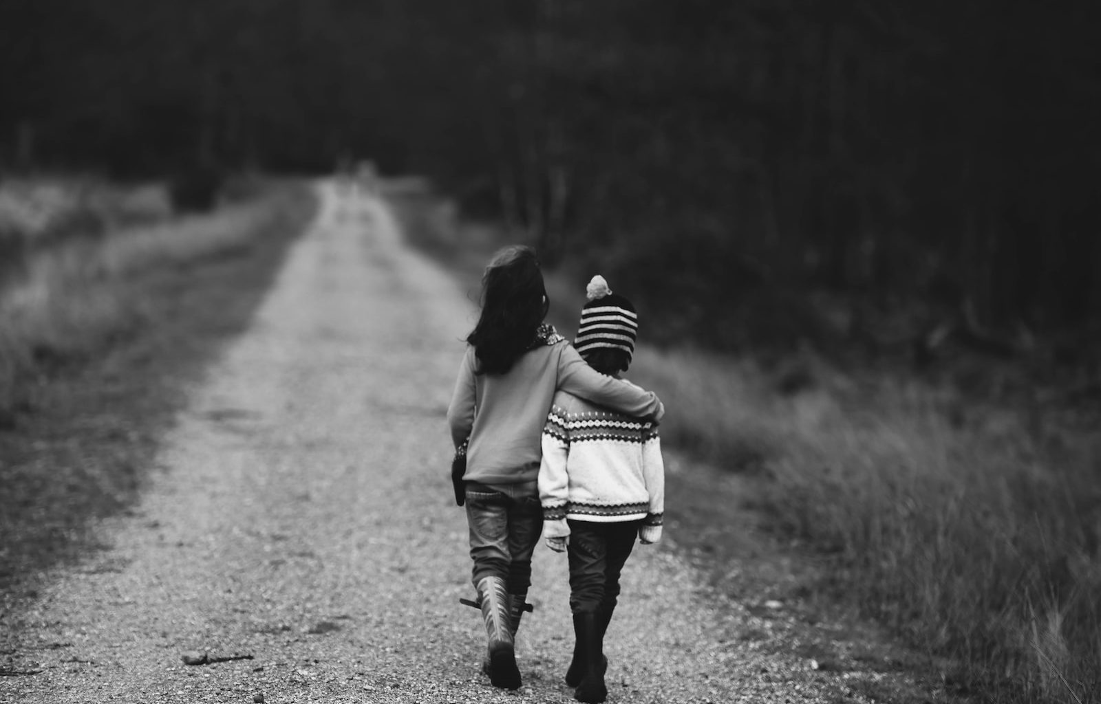 grayscale photography of kids walking on road