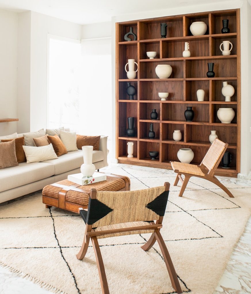 a living room filled with furniture and a book shelf