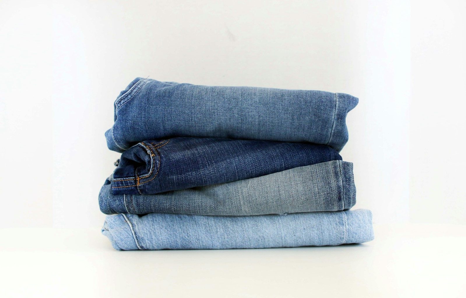 a stack of jeans sitting on top of each other