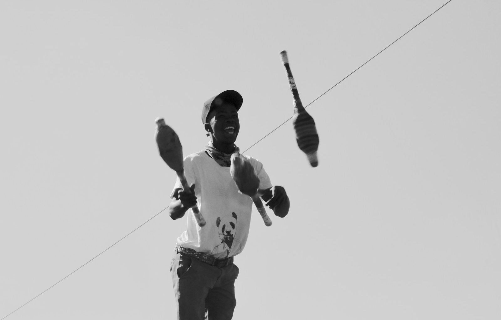 a black and white photo of a man holding a baseball bat