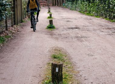 a person riding a bike down a dirt road