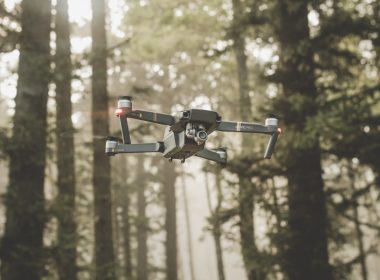 gray and black DJI Mavic Pro quadcopter drone on mid top air near forest at daytime