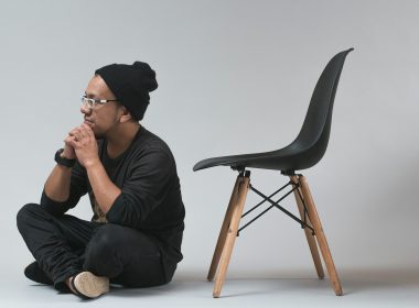 man sitting near black chair