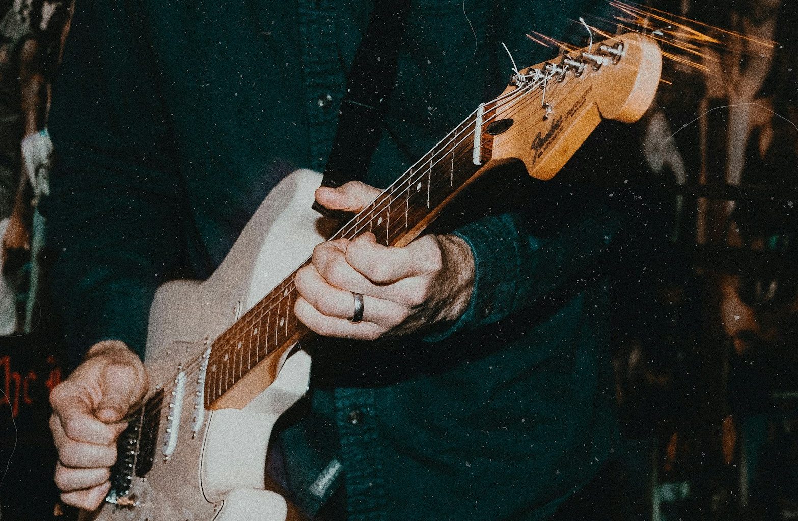 person holding white electric guitar