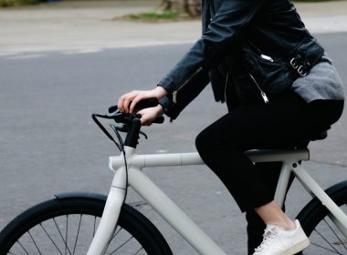 person in black jacket riding on white bicycle during daytime