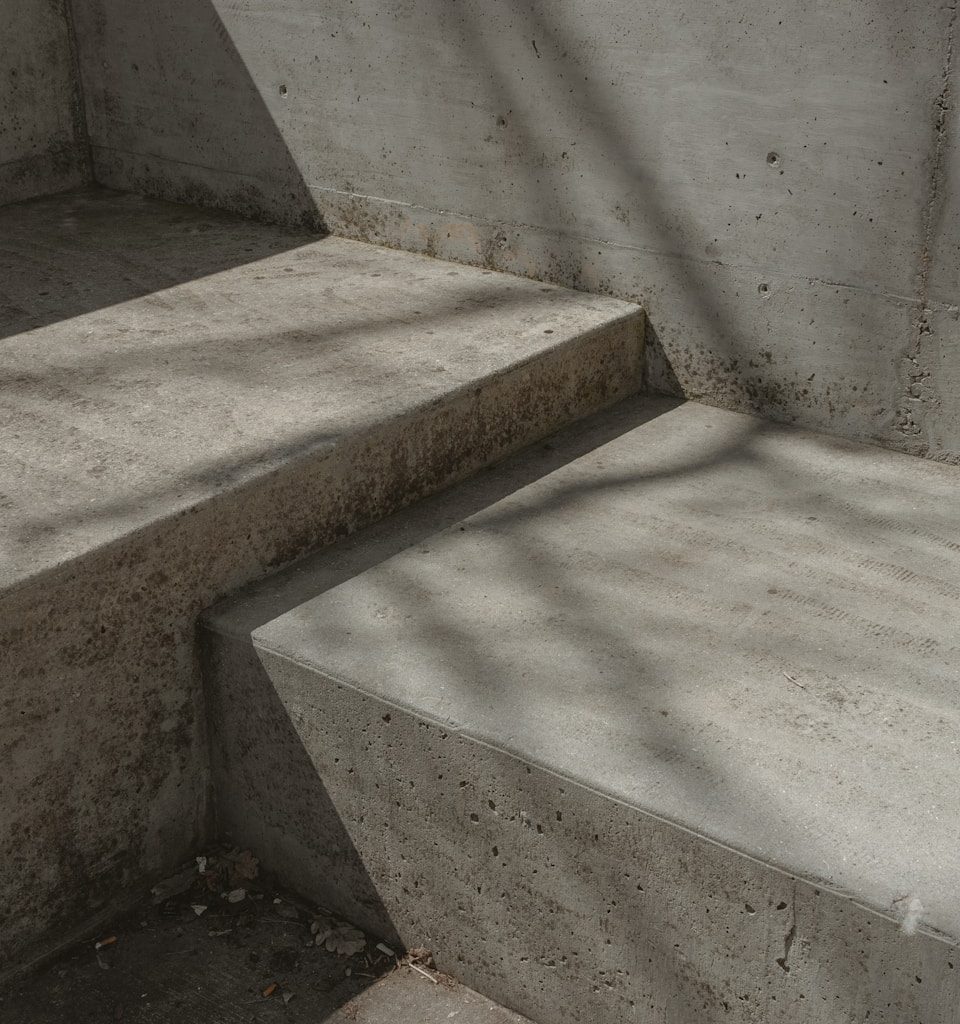 a concrete bench sitting next to a cement wall