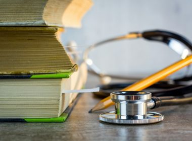 a stethoscope sitting on top of a pile of books