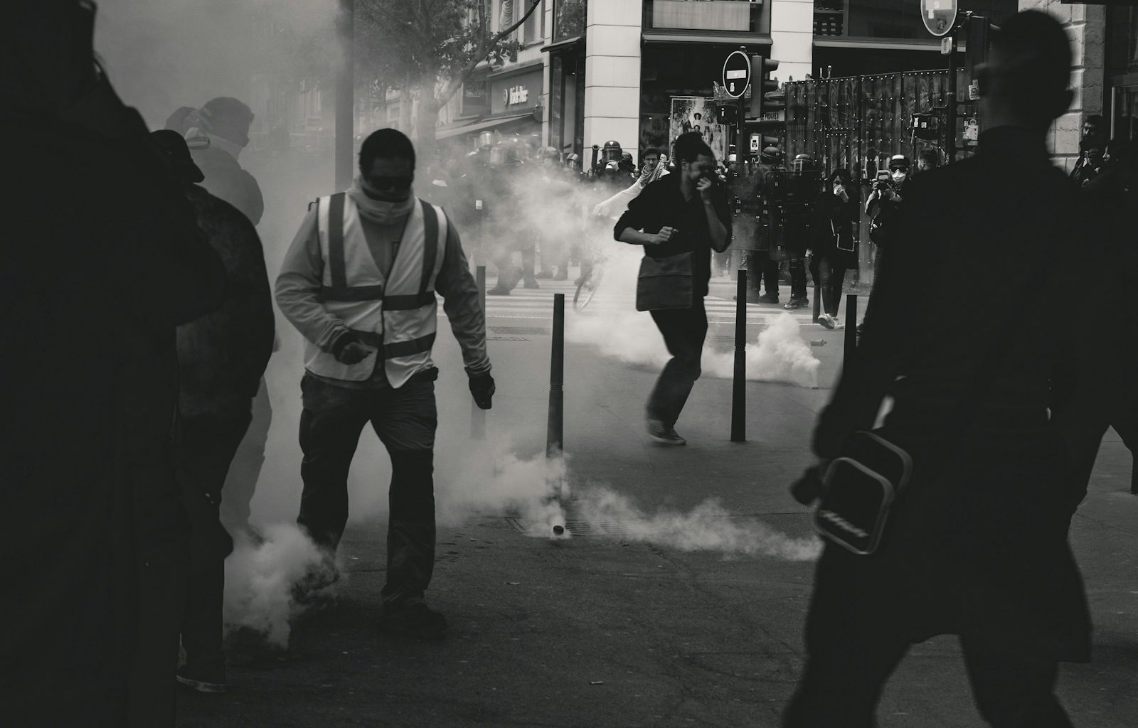 grayscale photo of people near smoke
