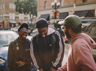 three men in jacket laughing at each other