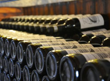 a bunch of bottles of wine are lined up