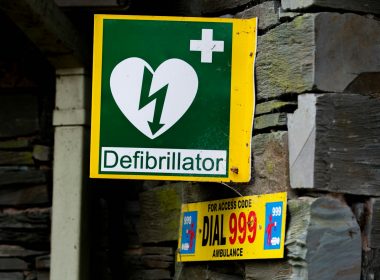 a green and yellow sign with a heart on it