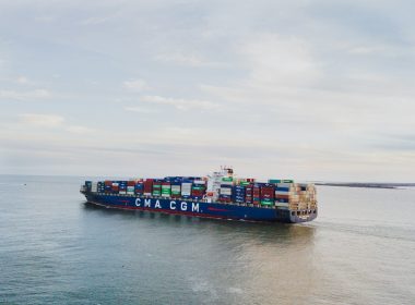 a large container ship sailing across a body of water