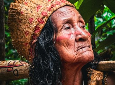 An old woman with a drum in her hand