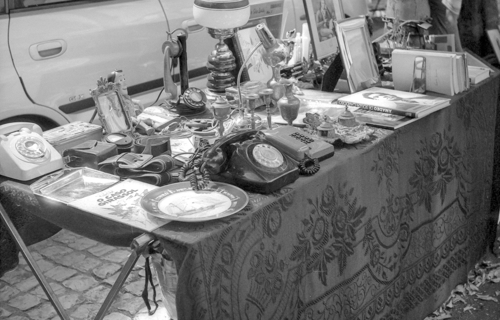 grayscale photo of table with plates and mugs