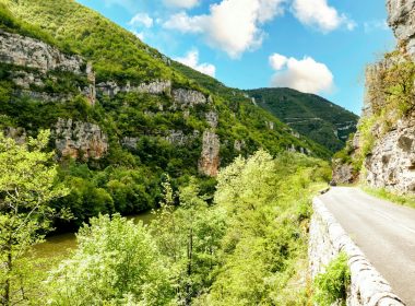 A scenic view of a mountain with a river running through it