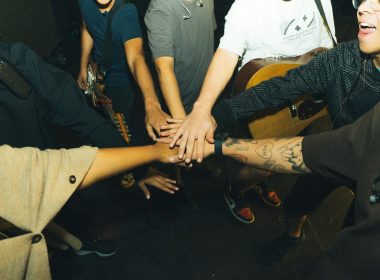 a group of people holding hands in a circle