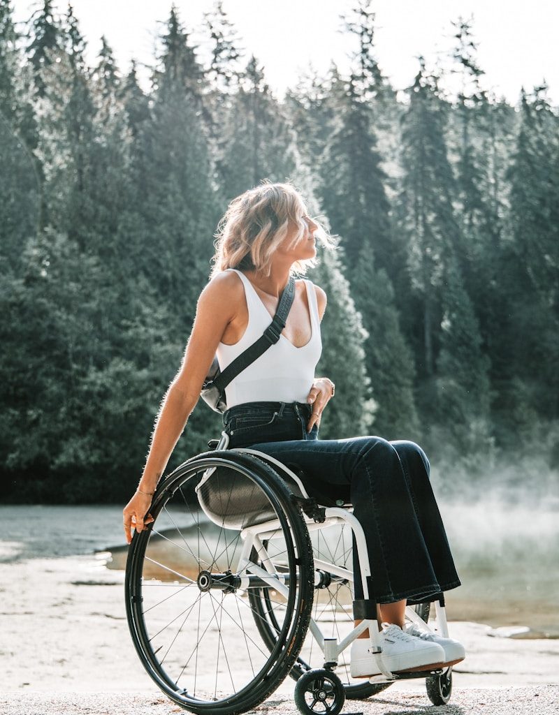 woman riding wheelchair near trees