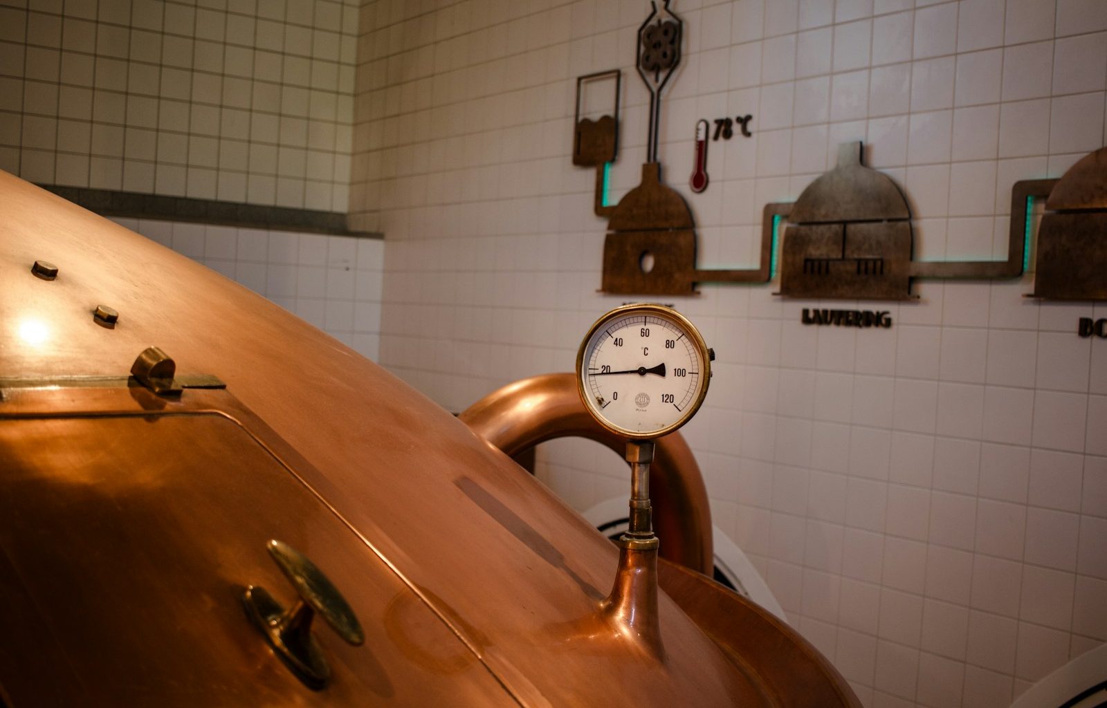 A large copper pot with a clock on top of it