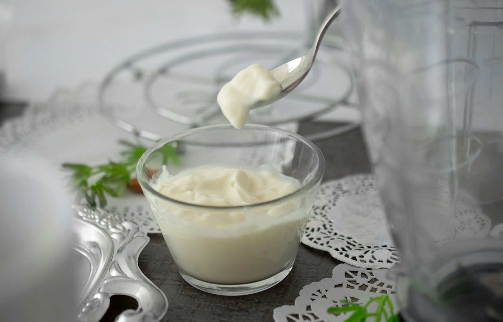 close-up photo of white cream in clear shot glass