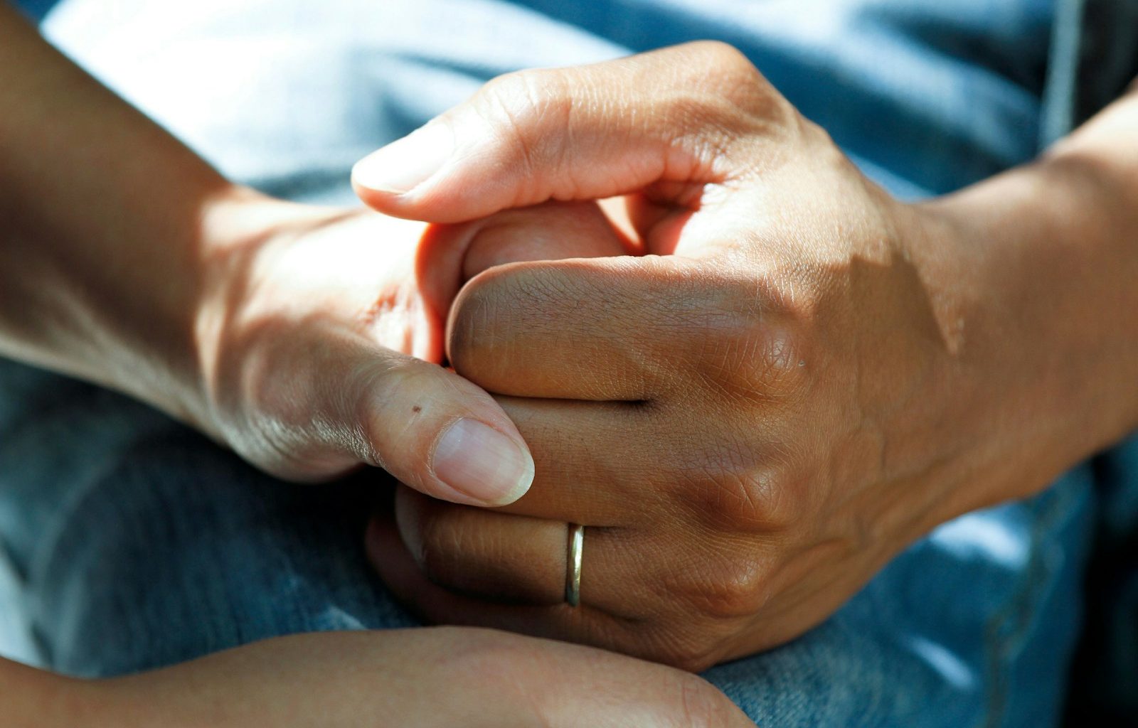 person wearing gold wedding band