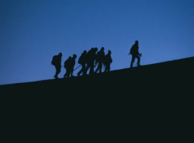 a group of people standing on a hill
