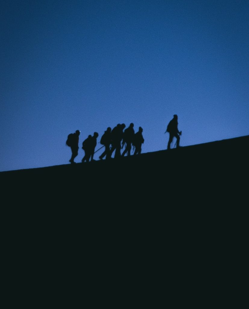 a group of people standing on a hill