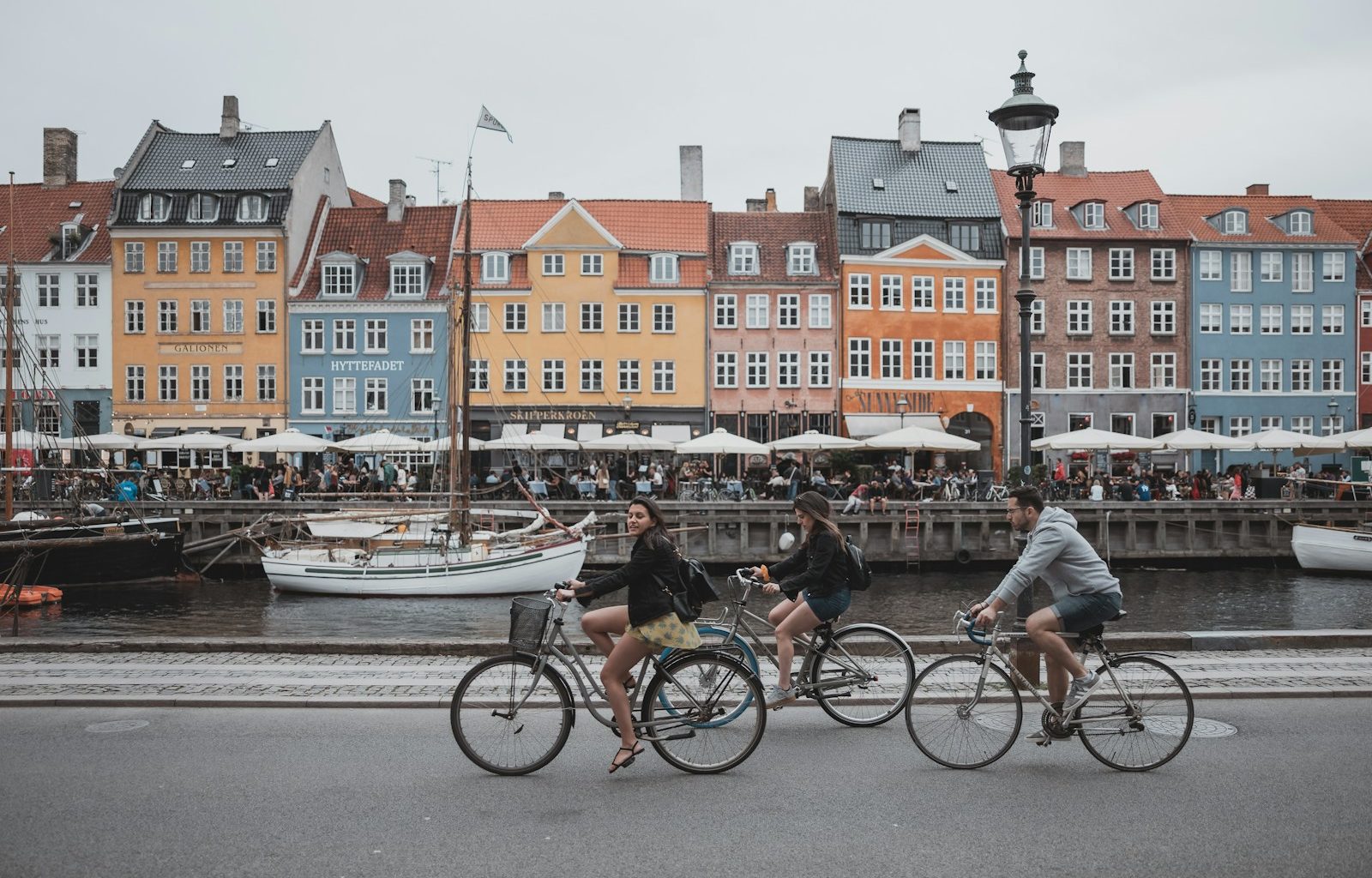 three people riding bicycles