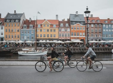 three people riding bicycles