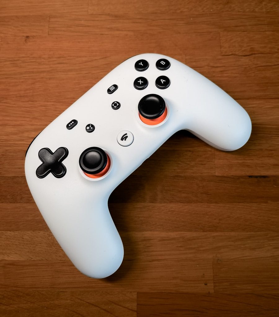 a white controller sitting on top of a wooden floor