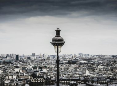 a street light in front of a cityscape