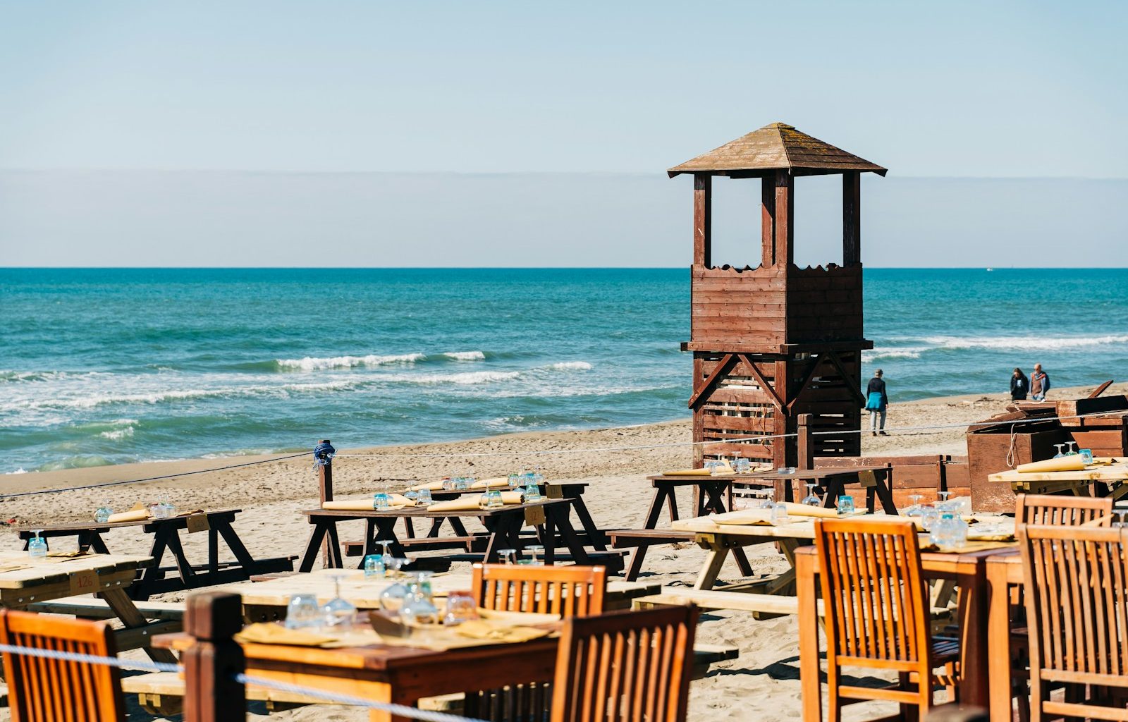 brown wooden lifeguard tower on beach during daytime
