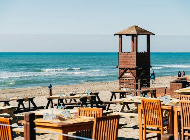 brown wooden lifeguard tower on beach during daytime