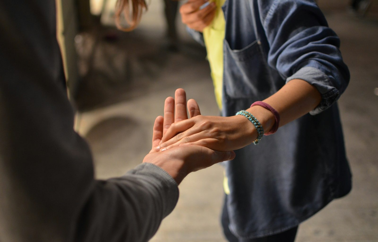 man and woman holding hands on street
