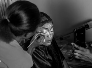 a black and white photo of a woman using a cell phone