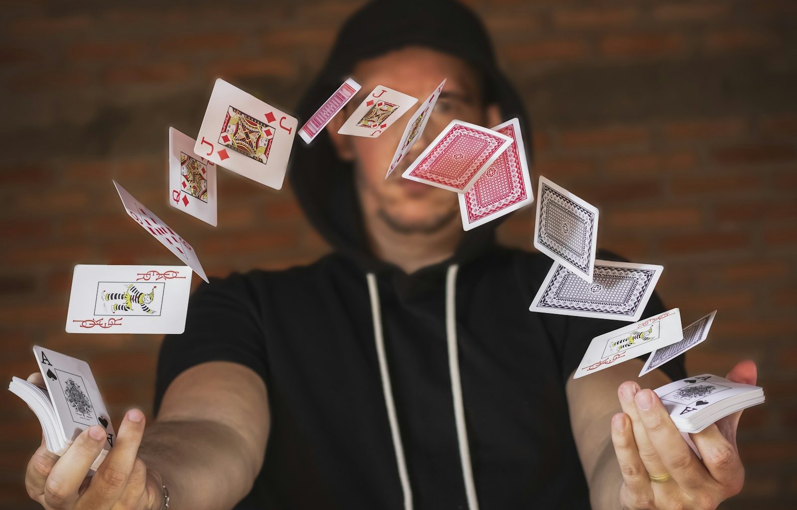 woman in black and white crew neck t-shirt holding playing cards